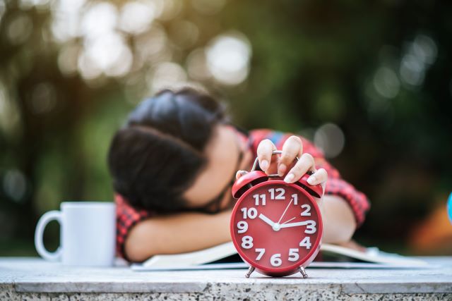 young-girl-lying-down-desk-after-reading-book